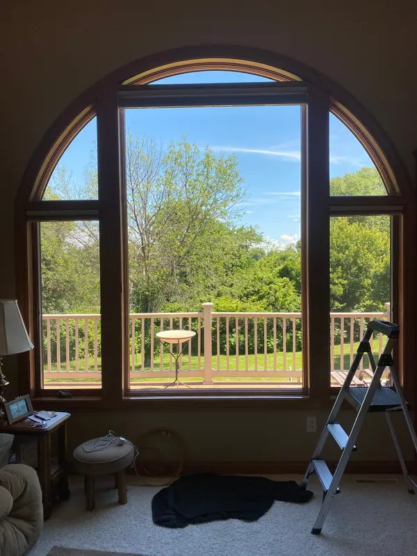 Clean arched windows with a clear view of the backyard