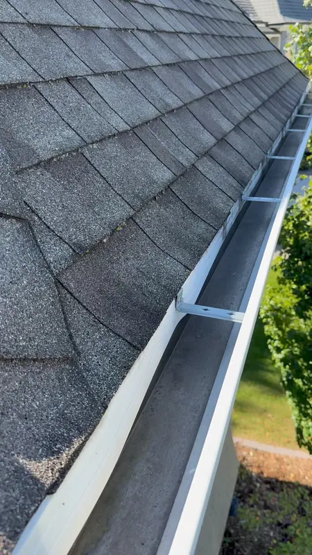 Cleared gutter along a shingle roof