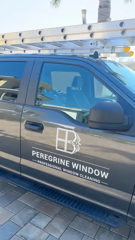 A Peregrine Window Cleaning truck with ladders