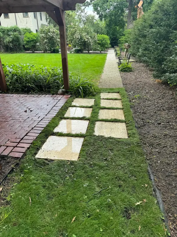 Freshly washed stone pavers set in grass
