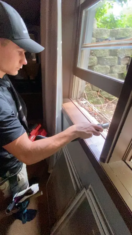 Hand-cleaning the track and sill of a double-hung window