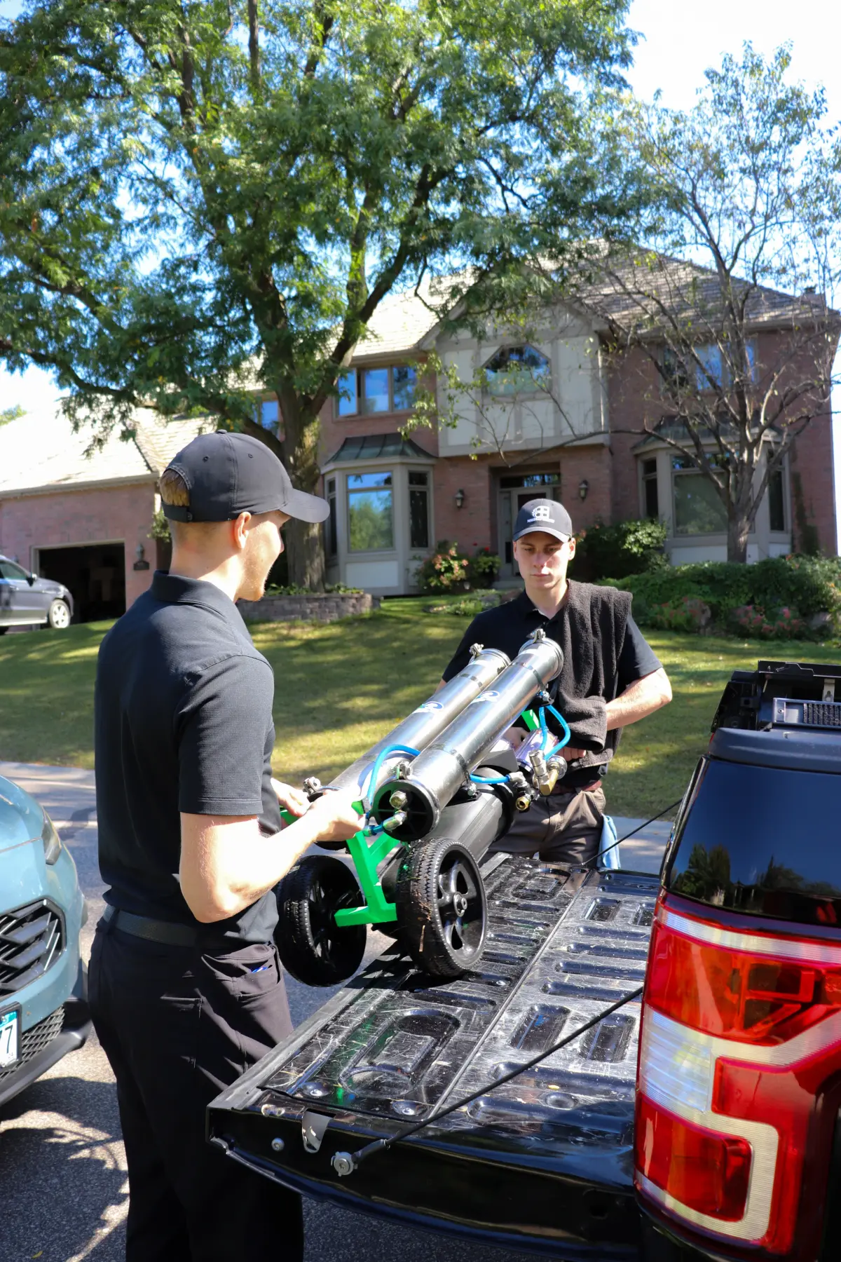 The Peregrine crew unloading water-fed pole gear from the truck