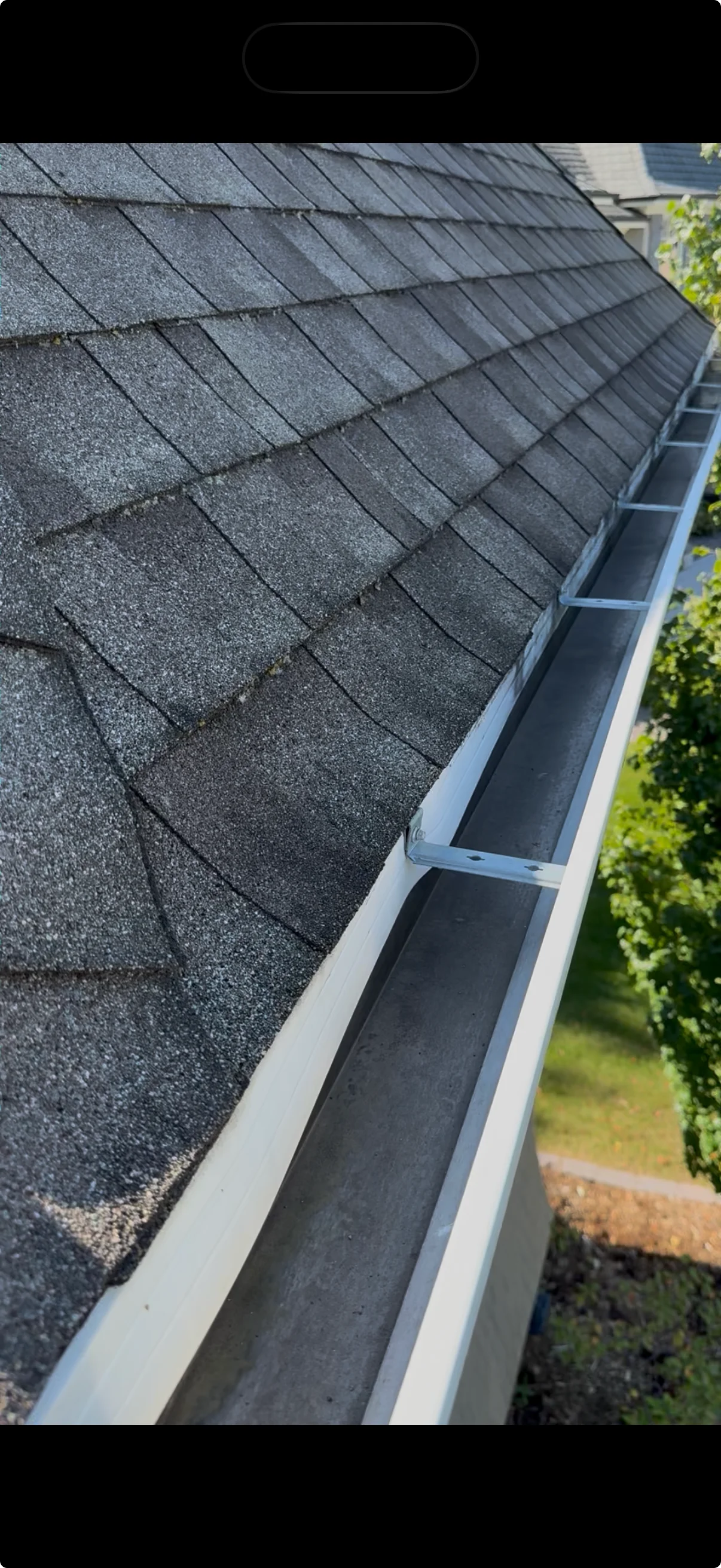 A cleaned gutter run along a roof edge